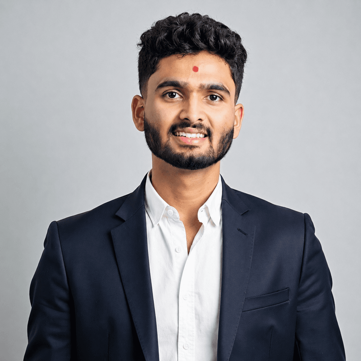 Shubham Patel wearing a dark suit and white shirt